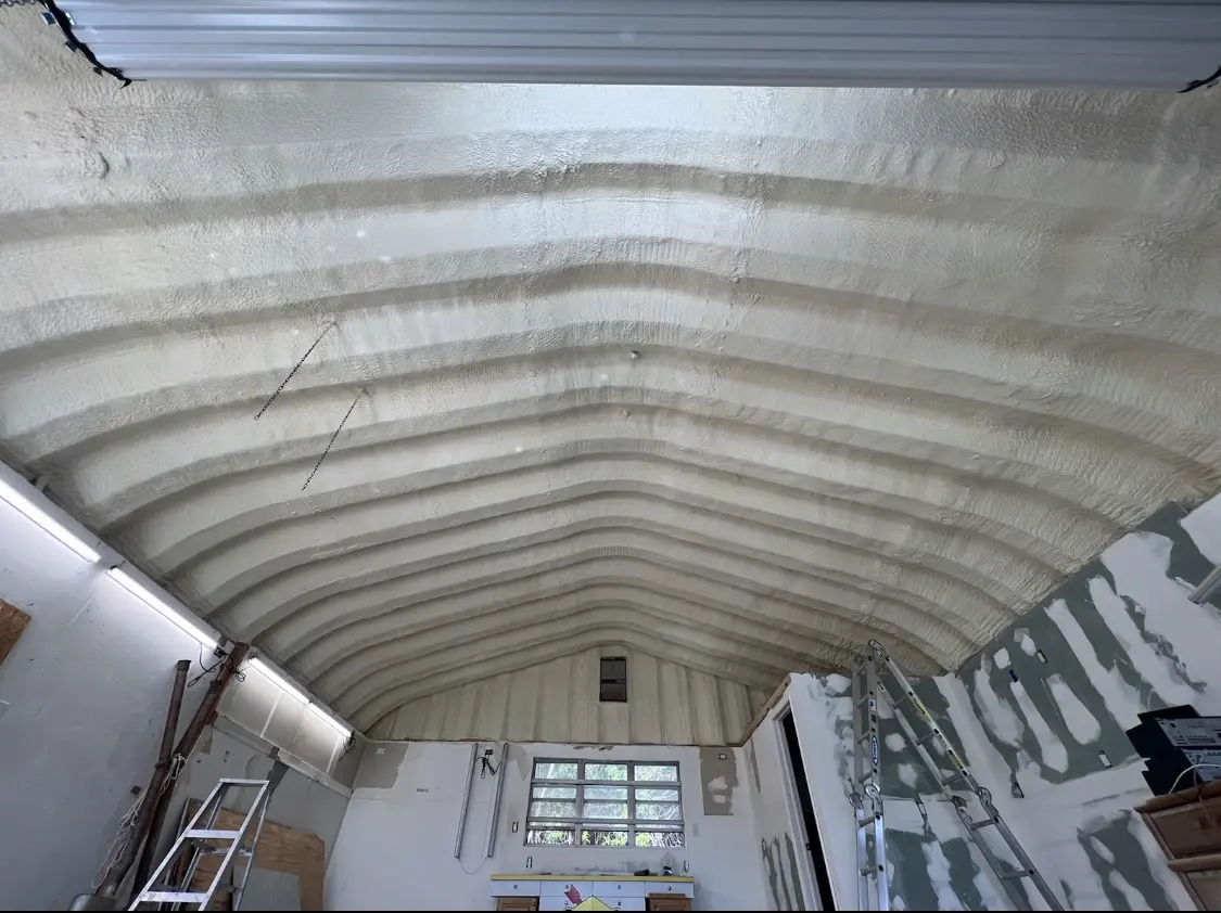 Spray polyurethane foam applied to the underside of a metal roof deck in Jackson